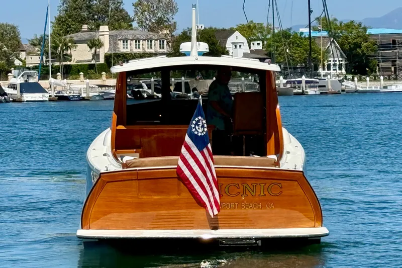 Picnic Yacht Photos Pics 2002 Palm Beach Motor Yachts Avalon 38 in marina, displaying American flag.