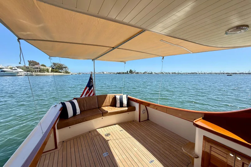 Picnic Yacht Photos Pics Luxurious 2002 Palm Beach Avalon 38 yacht with shaded deck and scenic water view.