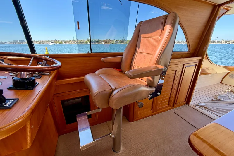 Picnic Yacht Photos Pics Luxurious helm seat on 2002 Palm Beach Motor Yachts Avalon 38, overlooking serene waters.