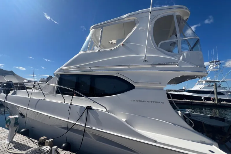  Yacht Photos Pics 2004 Silverton 48 Convertible yacht docked under clear blue sky.