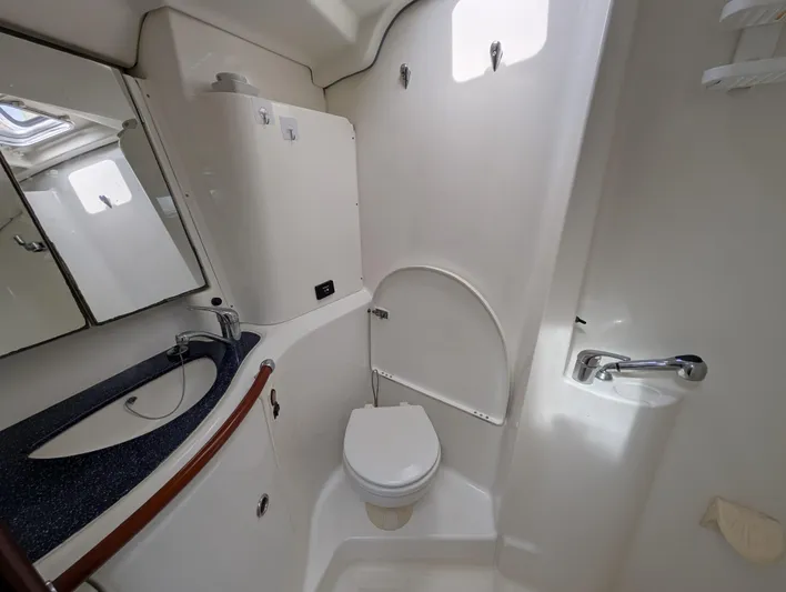 Seastar Yacht Photos Pics Bathroom interior of 2003 Beneteau Oceanis 473 yacht, featuring sink and toilet.