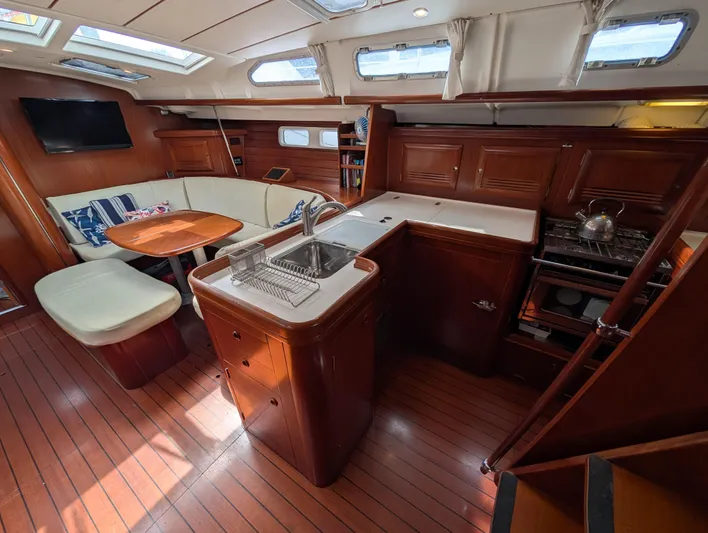 Seastar Yacht Photos Pics Interior of 2003 Beneteau Oceanis 473 yacht with kitchen and seating area.