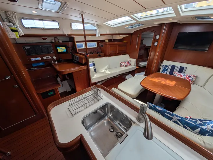 Seastar Yacht Photos Pics Interior of 2003 Beneteau Oceanis 473 yacht with modern kitchen and cozy seating area.