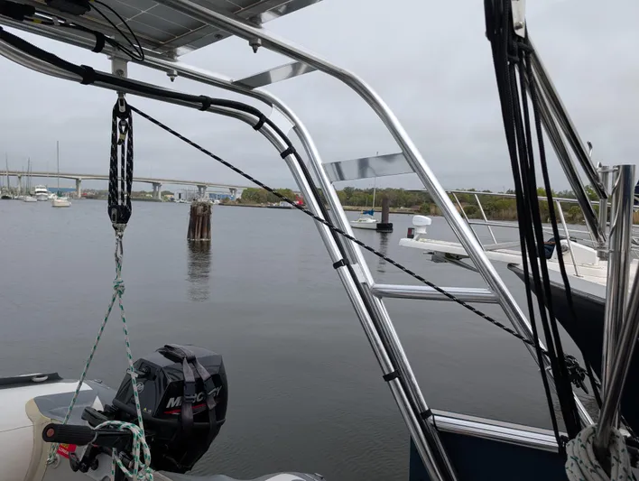 Seastar Yacht Photos Pics 2003 Beneteau Oceanis 473 sailboat with marina view, featuring metal framework and outboard motor.