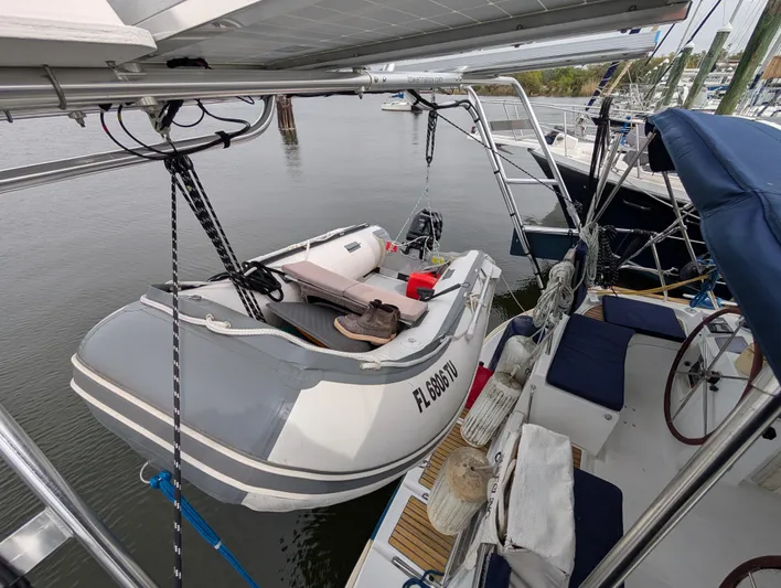 Seastar Yacht Photos Pics 2003 Beneteau Oceanis 473 sailboat with dinghy on davits, docked in a marina.