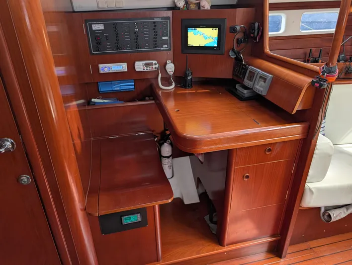 Seastar Yacht Photos Pics Navigation station of 2003 Beneteau Oceanis 473 yacht with control panels and seating.
