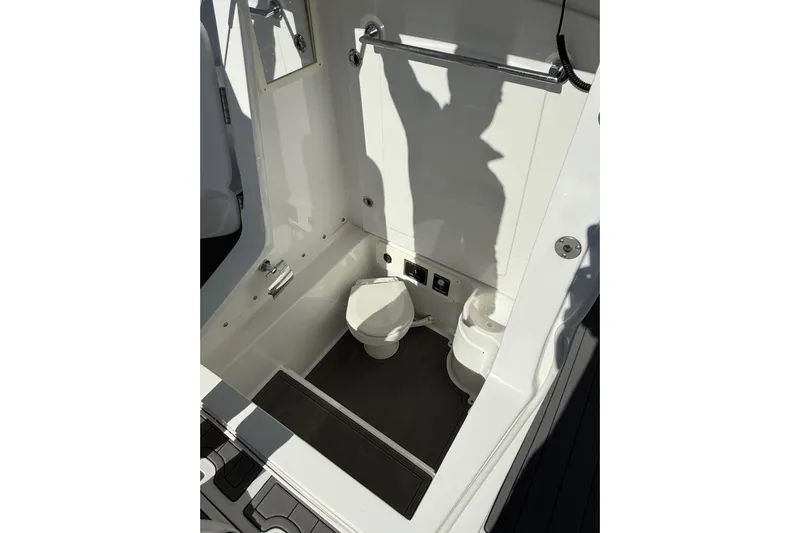  Yacht Photos Pics 2020 Midnight Express 34 Open boat interior with compact marine toilet.