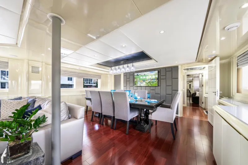 The Pearl Yacht Photos Pics Luxurious dining area on 1998 Intermarine 118 yacht with elegant decor and hardwood flooring.