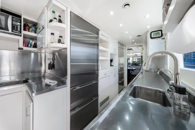 The Pearl Yacht Photos Pics Modern kitchen interior on 1998 Intermarine 118 yacht, featuring stainless steel appliances and sleek design.