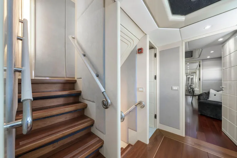 The Pearl Yacht Photos Pics Luxurious interior of 1998 Intermarine 118 yacht with elegant wooden staircase and modern design.