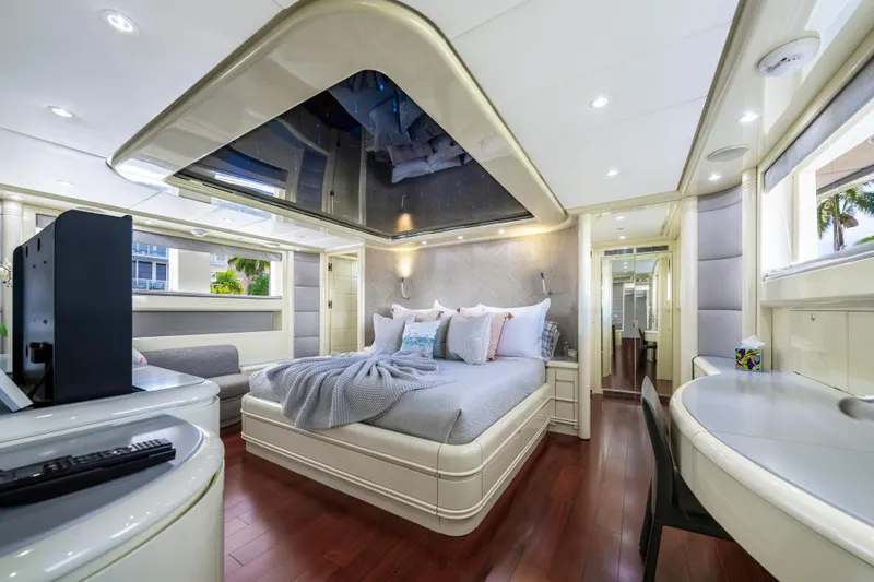 The Pearl Yacht Photos Pics Luxurious bedroom interior of 1998 Intermarine 118 yacht with modern decor and wood flooring.