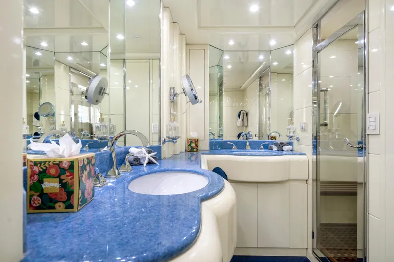 The Pearl Yacht Photos Pics Luxurious bathroom with blue countertop in 1998 Intermarine 118 yacht.