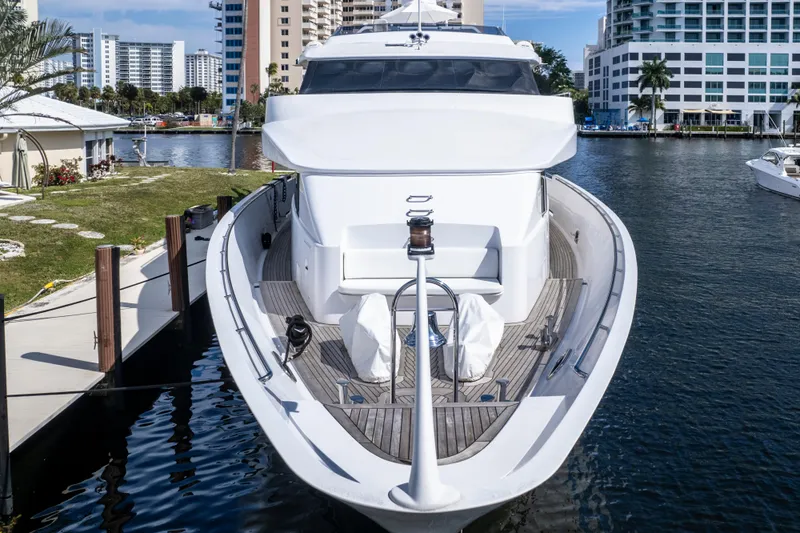 The Pearl Yacht Photos Pics Luxury 1998 Intermarine 118 yacht docked in a marina, surrounded by modern buildings.