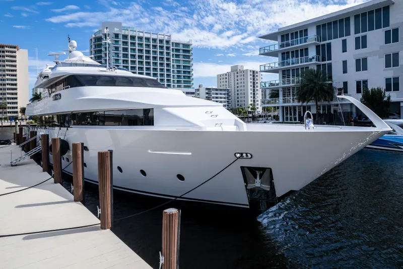 The Pearl Yacht Photos Pics Luxurious 1998 Intermarine 118 yacht docked in a modern marina setting.