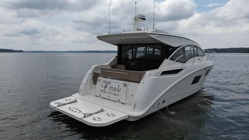 Finale Yacht Photos Pics 2017 Sea Ray Sundancer 400 yacht on calm waters under cloudy skies.