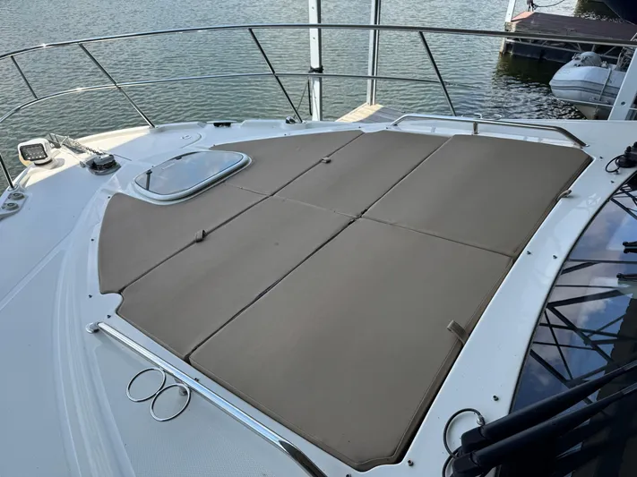 Finale Yacht Photos Pics 2017 Sea Ray Sundancer 400 boat with sunpad on deck, docked by the water.