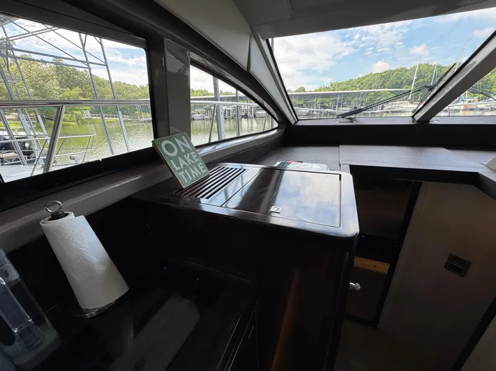 Finale Yacht Photos Pics Interior of 2017 Sea Ray Sundancer 400 yacht with lake view and "On Lake Time" sign.