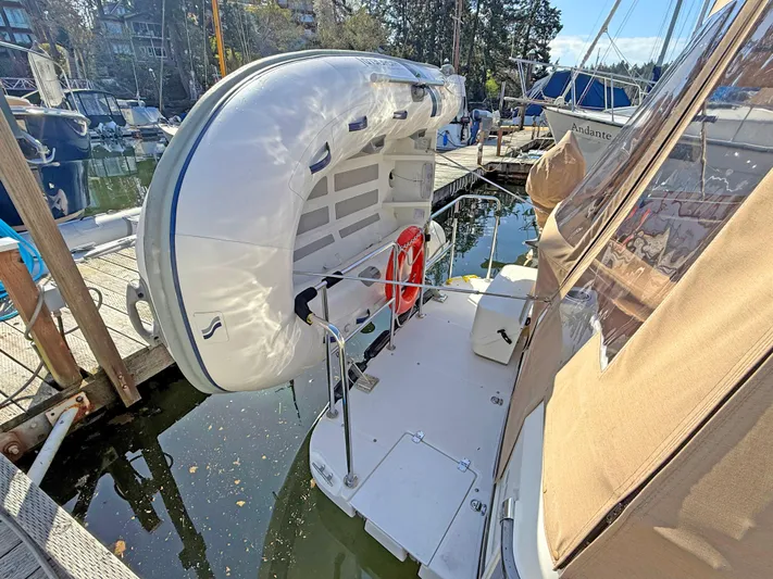 Salty Growler Yacht Photos Pics 2017 Ranger Tugs R-29 S with dinghy on davit at marina dock.