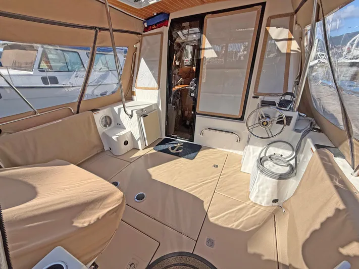 Salty Growler Yacht Photos Pics 2017 Ranger Tugs R-29 S interior with beige seating and helm station.