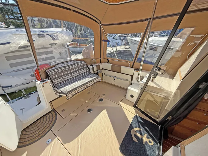 Salty Growler Yacht Photos Pics 2017 Ranger Tugs R-29 S interior with seating, windows, and nautical decor.
