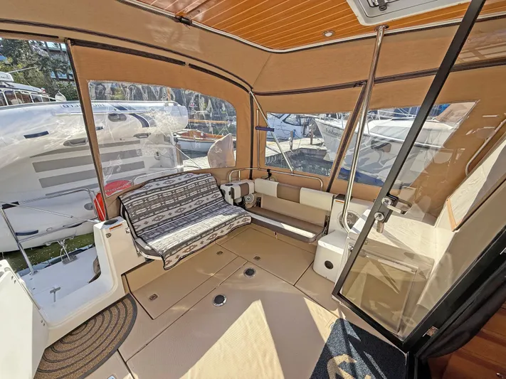 Salty Growler Yacht Photos Pics 2017 Ranger Tugs R-29 S interior with seating, glass door, and outdoor view.