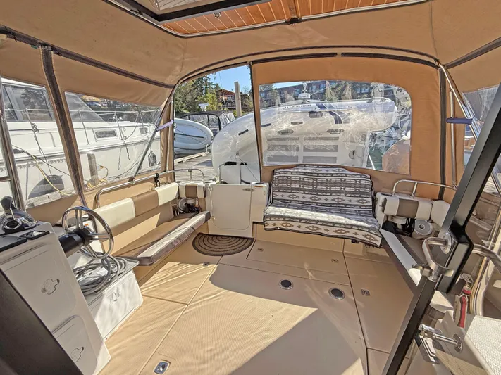 Salty Growler Yacht Photos Pics 2017 Ranger Tugs R-29 S interior with seating, steering wheel, and panoramic windows.