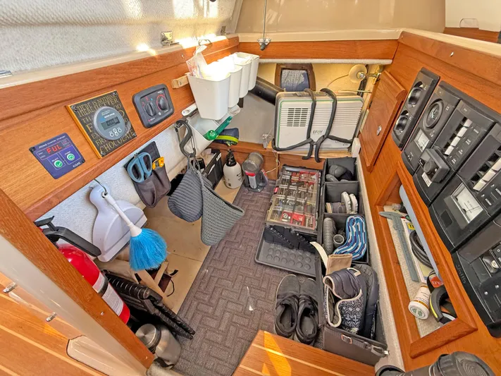 Salty Growler Yacht Photos Pics 2017 Ranger Tugs R-29 S interior storage with tools, equipment, and control panels.