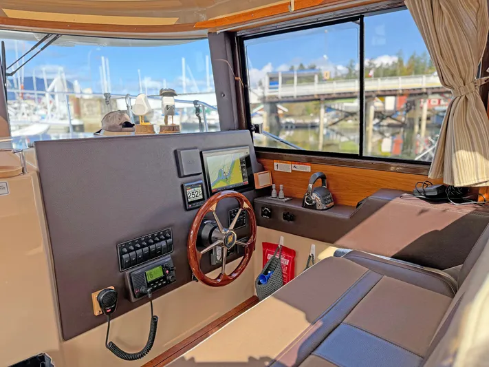 Salty Growler Yacht Photos Pics 2017 Ranger Tugs R-29 S helm with navigation equipment and marina view.