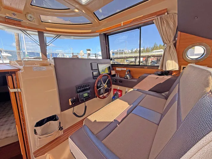 Salty Growler Yacht Photos Pics 2017 Ranger Tugs R-29 S interior with helm, seating, and large windows.