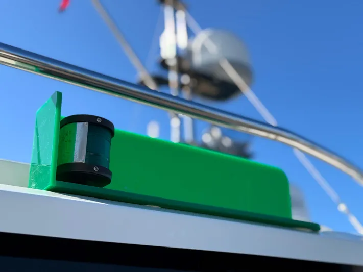 Salty Growler Yacht Photos Pics Close-up of a 2017 Ranger Tugs R-29 S boat's green navigation light against a clear blue sky.