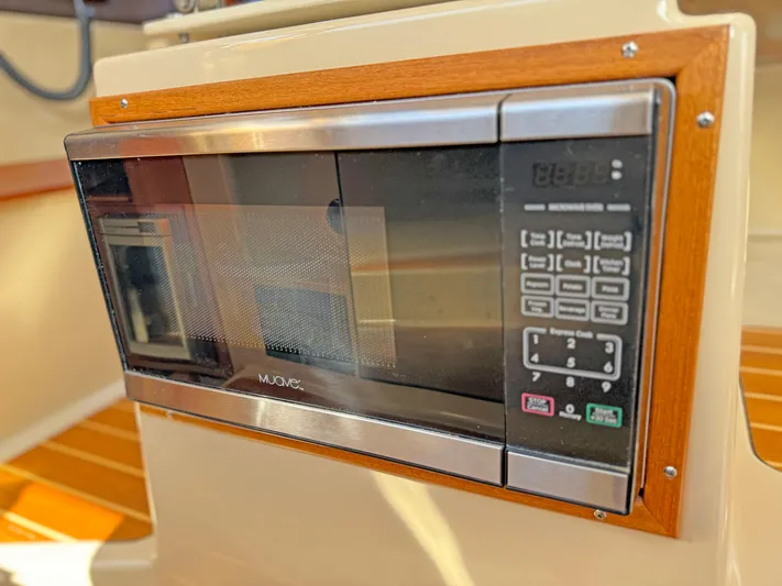 Salty Growler Yacht Photos Pics Built-in microwave on 2017 Ranger Tugs R-29 S boat, featuring wood trim and digital controls.