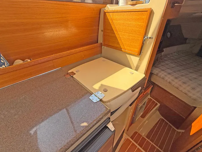 Salty Growler Yacht Photos Pics 2017 Ranger Tugs R-29 S interior with kitchenette and cozy cabin space.
