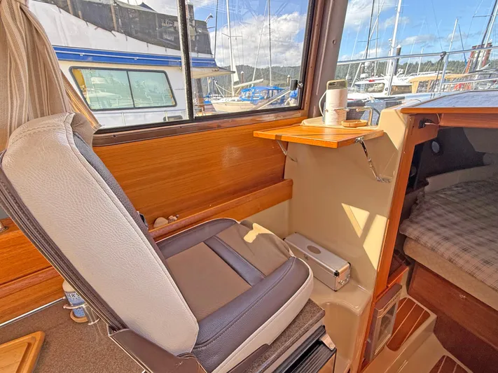 Salty Growler Yacht Photos Pics 2017 Ranger Tugs R-29 S interior with seating and foldable table, docked at marina.