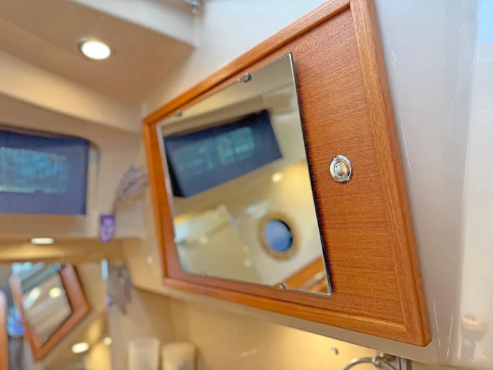 Salty Growler Yacht Photos Pics 2017 Ranger Tugs R-29 S interior with wooden cabinet and mirror detail.