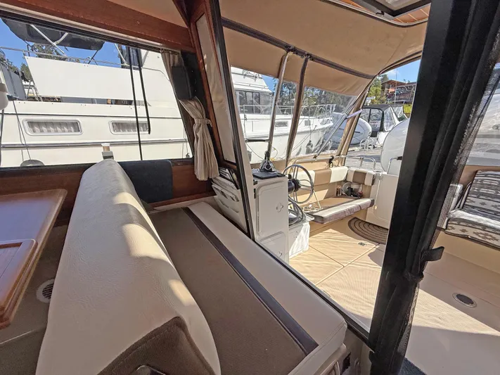 Salty Growler Yacht Photos Pics 2017 Ranger Tugs R-29 S interior with seating and helm, docked at marina.