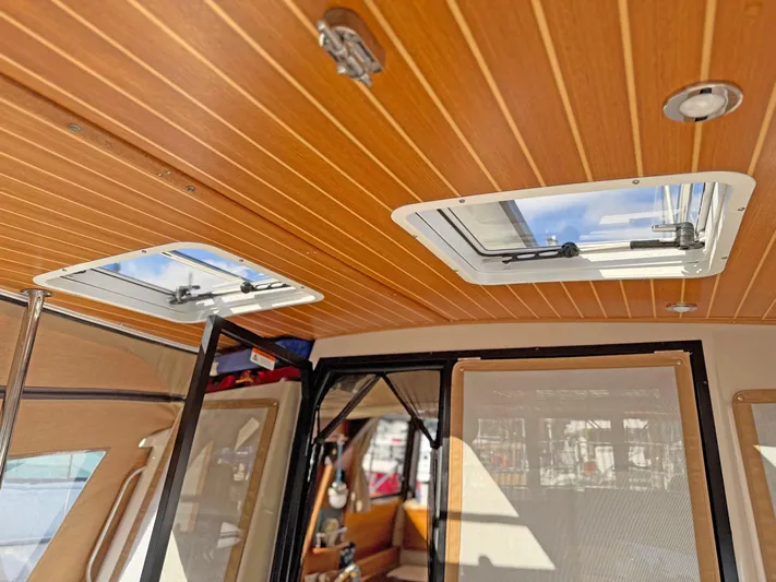 Salty Growler Yacht Photos Pics Interior view of 2017 Ranger Tugs R-29 S with wooden ceiling and skylights.