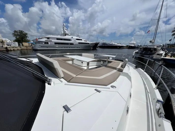  Yacht Photos Pics 2020 Galeon 680 Fly yacht with spacious deck seating, docked in a marina.