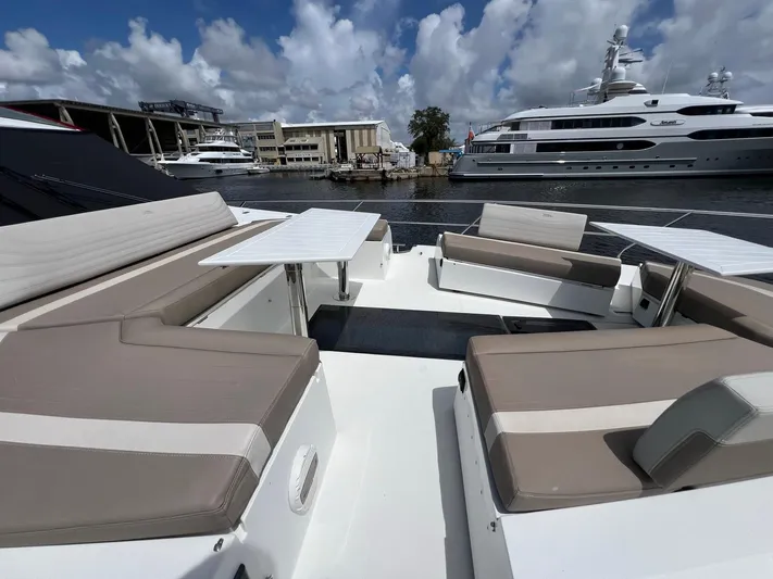  Yacht Photos Pics Luxurious seating area on 2020 Galeon 680 Fly yacht, docked with other yachts nearby.