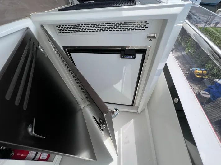  Yacht Photos Pics Open storage compartment on 2020 Galeon 680 Fly yacht, featuring a built-in refrigerator.
