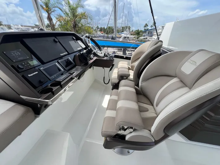  Yacht Photos Pics Cockpit of 2020 Galeon 680 Fly yacht with modern controls and plush seating.