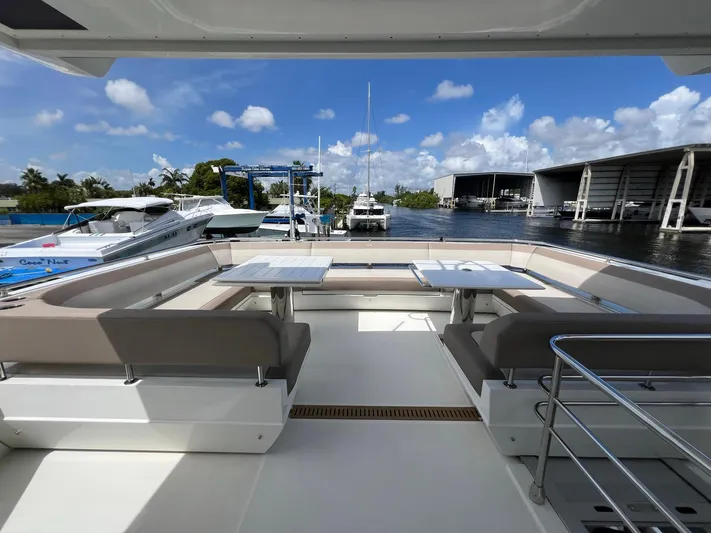  Yacht Photos Pics Luxurious seating area on 2020 Galeon 680 Fly yacht, docked at marina under blue sky.