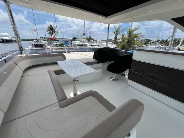  Yacht Photos Pics Luxurious 2020 Galeon 680 Fly yacht deck with seating and table, docked at marina.