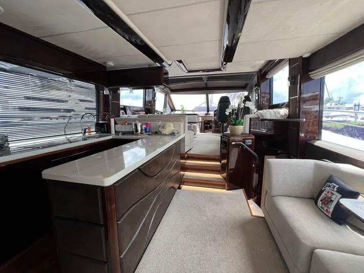  Yacht Photos Pics Luxurious interior of 2020 Galeon 680 Fly yacht with modern kitchen and seating area.