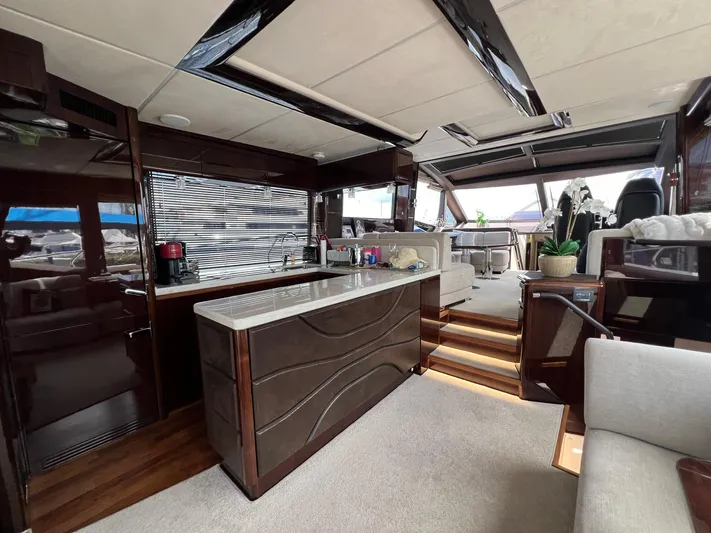  Yacht Photos Pics Luxurious interior of 2020 Galeon 680 Fly yacht with modern kitchen and seating area.