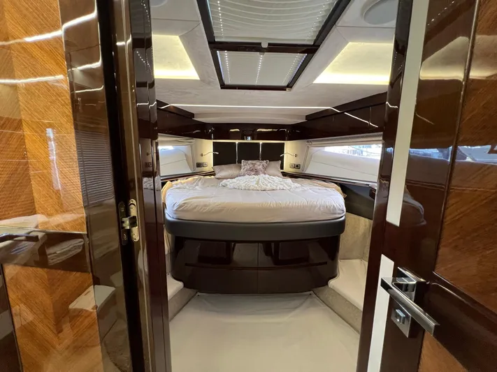  Yacht Photos Pics Luxurious bedroom interior of 2020 Galeon 680 Fly yacht with elegant wood finishes.