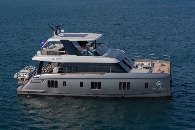  Yacht Photos Pics 2023 Sunreef 60 Power yacht cruising on open water.