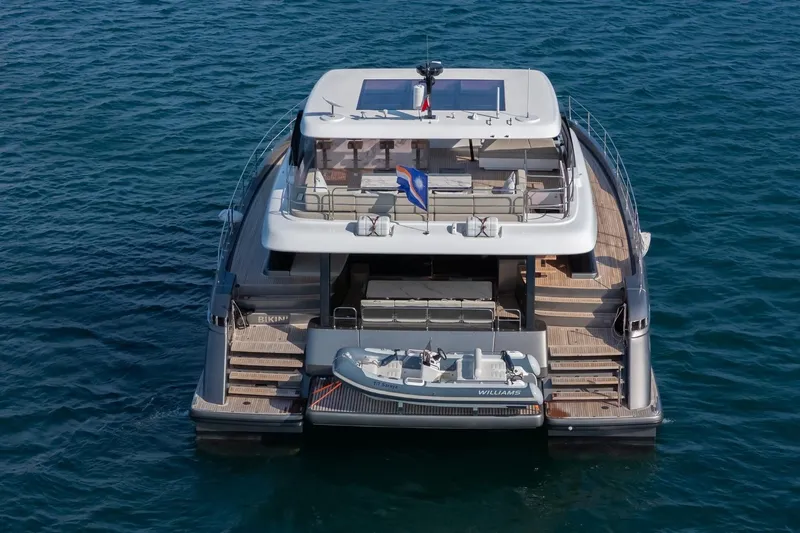  Yacht Photos Pics Luxurious 2023 Sunreef 60 Power yacht on serene blue waters, rear view.