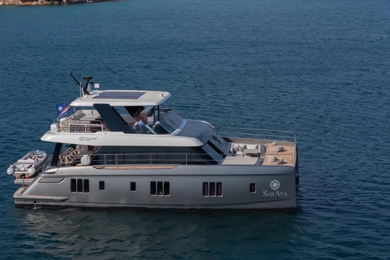  Yacht Photos Pics 2023 Sunreef 60 Power yacht cruising on open water.