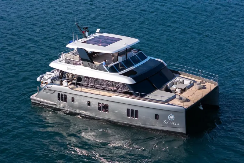 Yacht Photos Pics Luxurious 2023 Sunreef 60 Power yacht cruising on open water.
