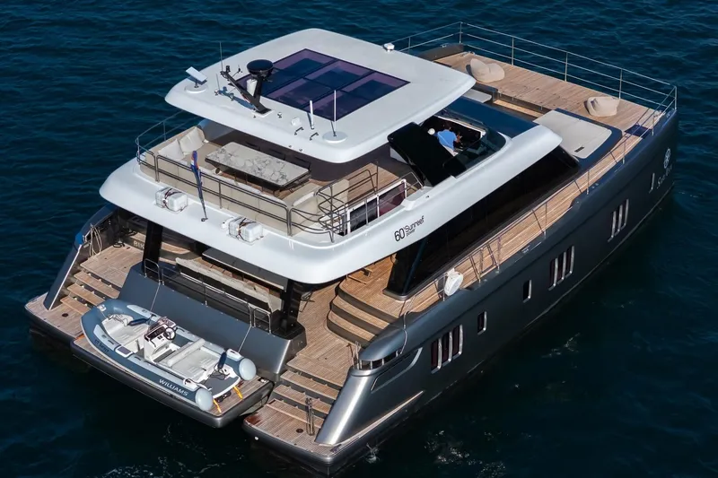  Yacht Photos Pics Luxurious 2023 Sunreef 60 Power yacht on open water, showcasing sleek design and spacious decks.